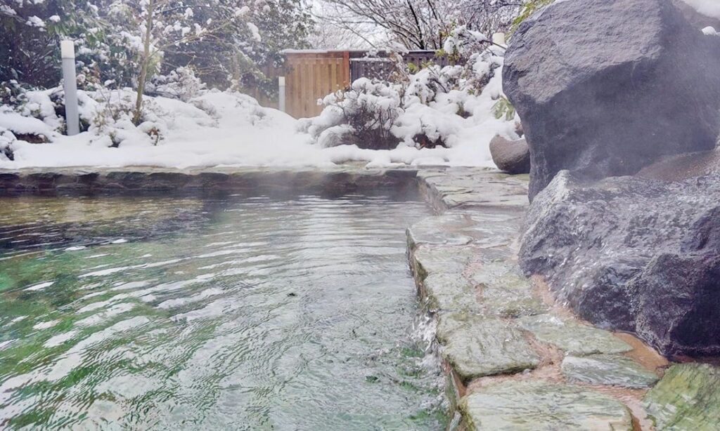 View of fresh snowfall from the women's open-air hot spring at Hotel Taikan