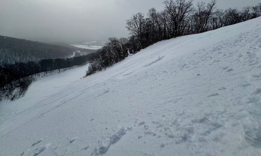 Wind swept powder on the sides of E1 trail’s final steeper pitch.
