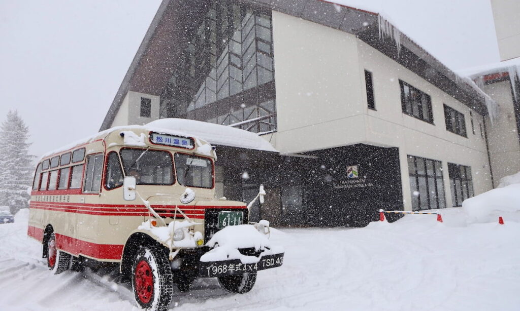 Entrance to the Hachimantai Mountain Hotel behind a vintage bus. Image: Hachimantai Resort