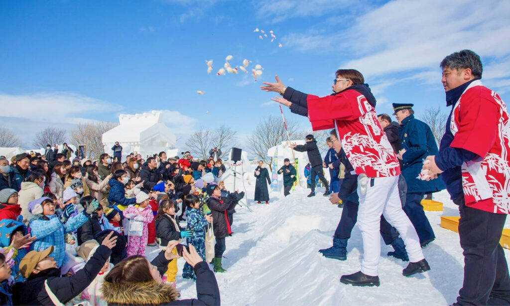 Japanese mochi being thrown during the Inukko Festival