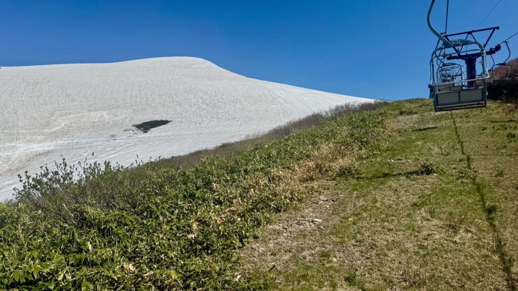 Grass under the pair lift with open trails to the left at Mt. Gassan Ski Area